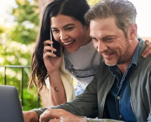 Woman and man looking at laptop